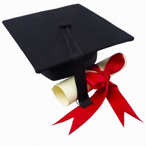 Close up of a graduation cap and a certificate with a ribbon